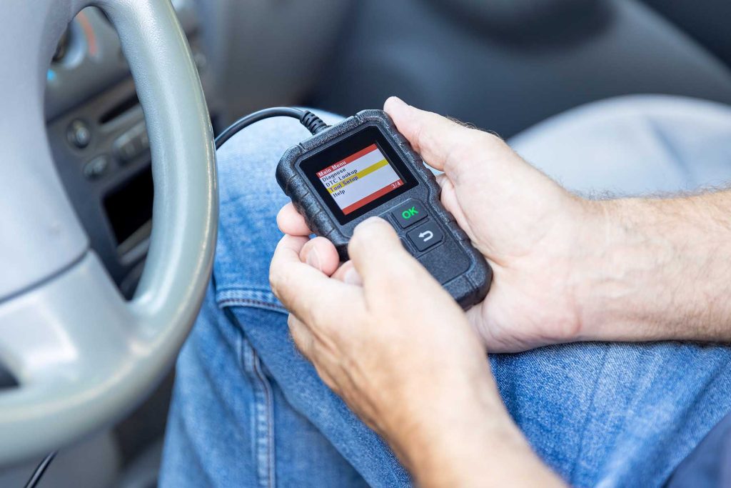 Using diagnostic car code reader to erase error codes and turn off check engine light