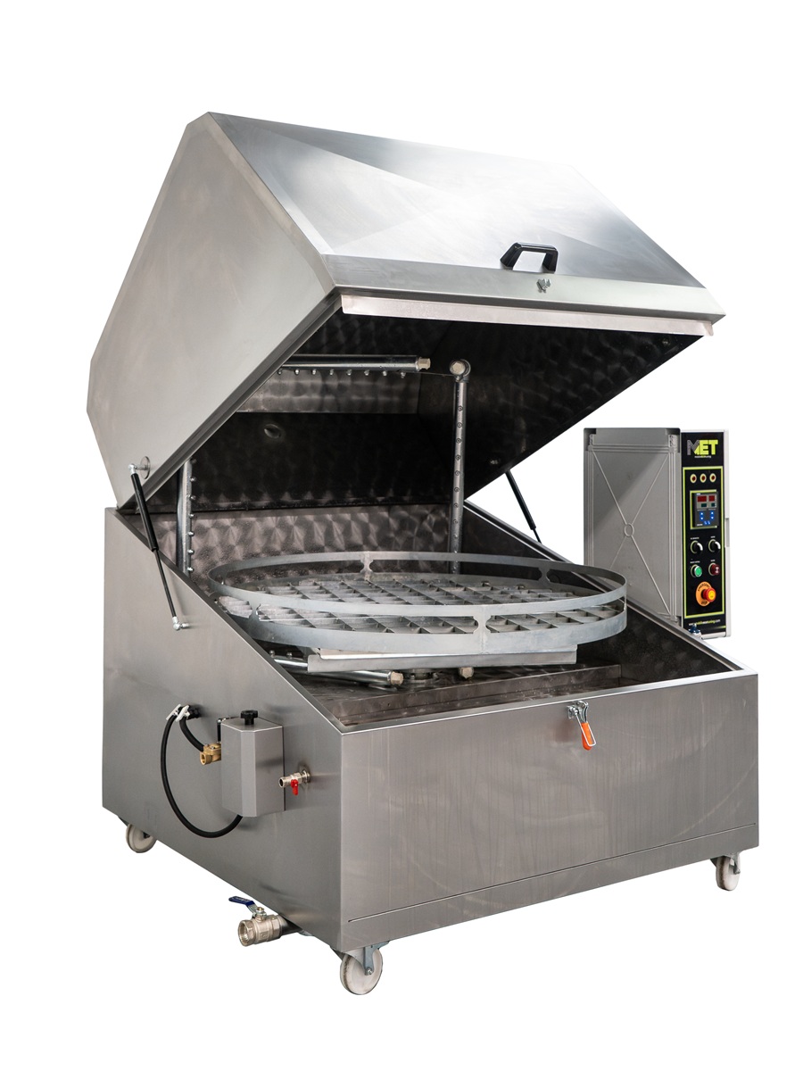 Side view of METCLEAN Rota S parts washer with open lid, rotating platform, and control panel for industrial cleaning.