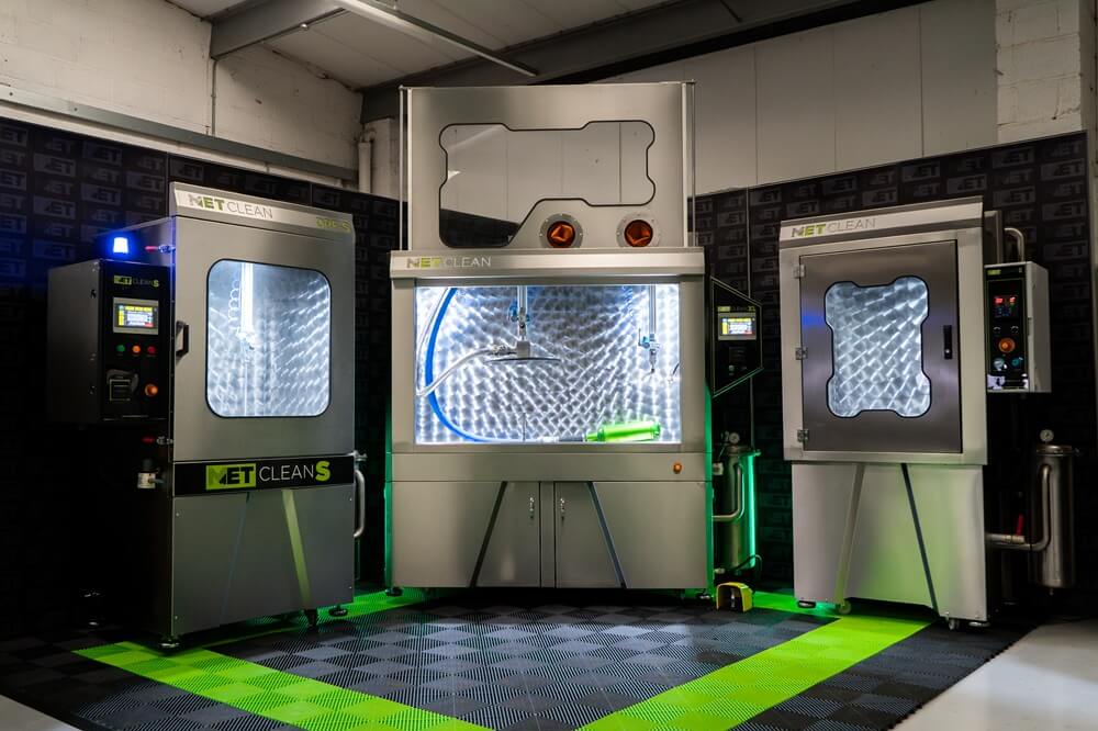 Three Metclean DPF cleaning machines arranged in a workshop setup showing the full cleaning system and control panels.